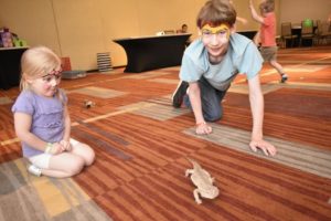 kids playing with a lizard 