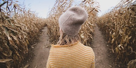 Woman standing in a corn maze