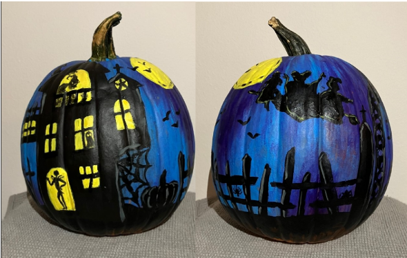 Painted dark blue pumpkin with a large black house with yellow windows and an outline of Jack and Oogie Boogie from Nightmare Before Christmas. The other side has a black low fence with a shadow of the three Hocus Pocus witches floating in the air.