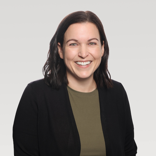 Woman smiling in a black coat