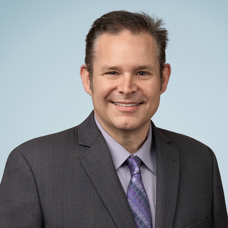 Man in brown hair smiling