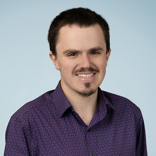 Man in brown hair smiling