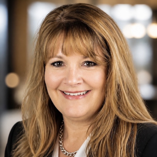 Woman is long light brown hair smiling