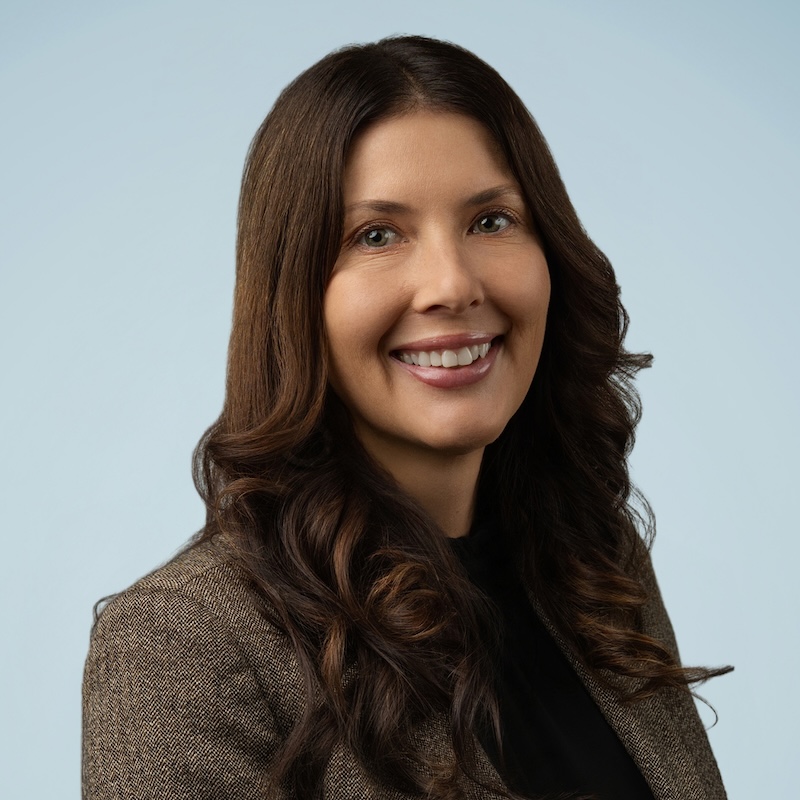 Woman in dark long brown hair smiling